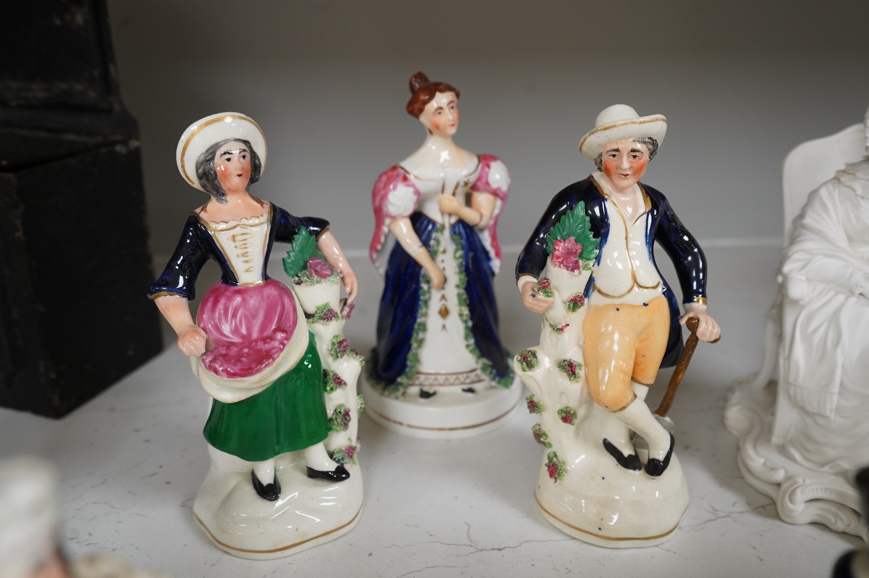 A group of mid-19th century Staffordshire porcelain figures, two models of zebras and a early 19th century Derby biscuit porcelain figure of a seated lady, largest 18cm high